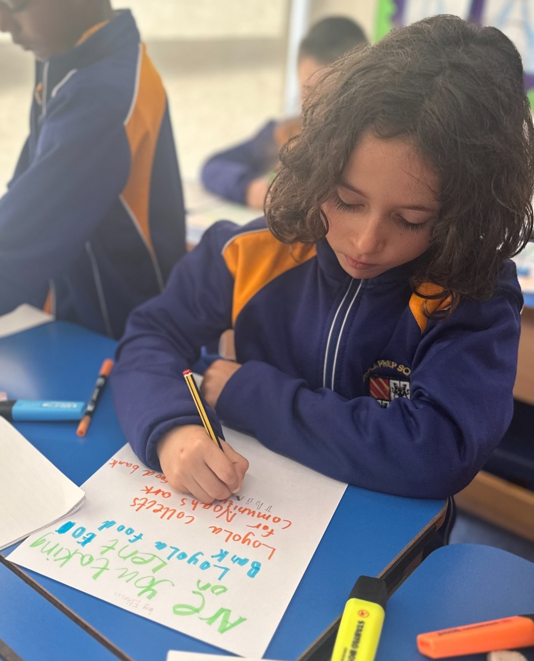 Loyola Prep boys making a foodbank poster